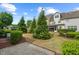 Grassy backyard of townhome with manicured lawn, shrubs, and an inviting outdoor space at 15 Plumas Drive Dr, Durham, NC 27705