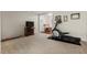 Spacious carpeted basement offering ample room for recreation with exercise equipment and tv at 15 Plumas Drive Dr, Durham, NC 27705