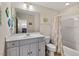 Bright bathroom featuring a white vanity with ample storage space and a shower-tub combination at 15 Plumas Drive Dr, Durham, NC 27705