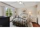 Comfortable bedroom featuring a large window, tray ceiling, plush rug, and neutral color palette at 15 Plumas Drive Dr, Durham, NC 27705