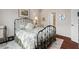 Bedroom with a decorative metal bed frame, plush rug, and ample natural light near an ensuite bathroom at 15 Plumas Drive Dr, Durham, NC 27705