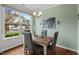 Cozy dining area featuring a rustic wood table, stylish seating, and a large window at 15 Plumas Drive Dr, Durham, NC 27705