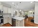 Open kitchen layout featuring granite countertops, stainless steel appliances, and hardwood floors at 15 Plumas Drive Dr, Durham, NC 27705