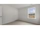 Bright bedroom with a window, neutral carpet, and fresh paint at 152 Global Ave, Fuquay Varina, NC 27526