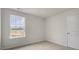 Cozy bedroom with a bright window, neutral carpet, and fresh paint at 152 Global Ave, Fuquay Varina, NC 27526