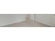 Neutral bedroom features fresh paint, baseboard trim, and a view into the hall at 152 Global Ave, Fuquay Varina, NC 27526