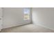 Bright bedroom with fresh paint, a large window, and neutral carpet at 152 Global Ave, Fuquay Varina, NC 27526