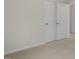 Carpeted closet features a white sliding double door in a room with white walls at 152 Global Ave, Fuquay Varina, NC 27526