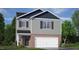 Charming two-story home with gray siding, brick accents, and a two-car garage, set against a blue sky at 152 Global Ave, Fuquay Varina, NC 27526