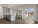 Open living space with gray cabinets, granite countertops, and sliding doors leading to outdoor space at 152 Global Ave, Fuquay Varina, NC 27526