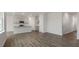 Open living space featuring new floors and kitchen with gray cabinets and granite countertop at 152 Global Ave, Fuquay Varina, NC 27526