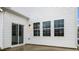 Back patio area with sliding door access and windows with white siding at 152 Global Ave, Fuquay Varina, NC 27526