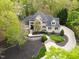 Expansive aerial view of a brick home featuring lush landscaping and a winding driveway at 16106 Morehead, Chapel Hill, NC 27517