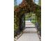 Tranquil backyard entrance with a floral archway leading to a serene outdoor space at 16106 Morehead, Chapel Hill, NC 27517