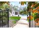Lush backyard view through iron gate, leading to a pool and outdoor seating area at 16106 Morehead, Chapel Hill, NC 27517