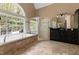 The Primary bathroom features a large soaking tub, a walk-in shower, and marble floors at 16106 Morehead, Chapel Hill, NC 27517