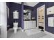 This elegant bathroom features dark blue walls, black-and-white floors, and a modern toilet at 16106 Morehead, Chapel Hill, NC 27517