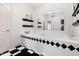 A luxury bathroom features a large soaking tub with decorative black accents and marble floors at 16106 Morehead, Chapel Hill, NC 27517