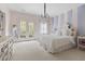 This cozy bedroom features carpeted floors and French doors to a balcony at 16106 Morehead, Chapel Hill, NC 27517
