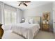 Bright bedroom features a ceiling fan, white bedding, and light-colored walls at 16106 Morehead, Chapel Hill, NC 27517