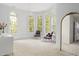 A cozy bedroom features large windows, carpeted floors, and decorative chairs at 16106 Morehead, Chapel Hill, NC 27517