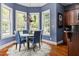 Charming dining room featuring blue chairs, a round table, and multiple windows providing ample natural light at 16106 Morehead, Chapel Hill, NC 27517