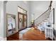 Bright foyer with hardwood floors, elegant staircase, and sophisticated decor at 16106 Morehead, Chapel Hill, NC 27517