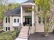 Elegant brick home featuring a columned front entrance with seasonal wreaths and manicured landscaping at 16106 Morehead, Chapel Hill, NC 27517