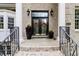 Charming front porch with double doors, decorative wreaths, and stylish potted plants at 16106 Morehead, Chapel Hill, NC 27517