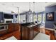 Open concept kitchen with stainless appliances, wood cabinets and a center island leading to a dining area at 16106 Morehead, Chapel Hill, NC 27517