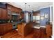 Spacious kitchen featuring dark wood cabinetry, stainless steel appliances, and a central island with granite countertops at 16106 Morehead, Chapel Hill, NC 27517