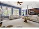 Bright, open living room with plush white couches, large windows, and an open floor plan to the kitchen at 16106 Morehead, Chapel Hill, NC 27517
