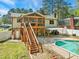 Spacious backyard features a pool, deck, large wood screened in porch, and lush green lawn at 1624 Cone Ave, Apex, NC 27502