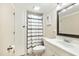 Bathroom featuring sink, toilet, dark framed mirror and shower with striped curtain at 1624 Cone Ave, Apex, NC 27502