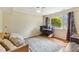 Bedroom features hardwood flooring, area rug, large window, and comfortable seating at 1624 Cone Ave, Apex, NC 27502