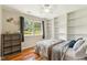 This cozy bedroom features wood flooring, a ceiling fan, and built in bookshelves at 1624 Cone Ave, Apex, NC 27502