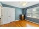 This cozy bedroom features a ceiling fan, closet, and large windows for natural light at 1624 Cone Ave, Apex, NC 27502