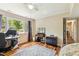 This comfortable bedroom includes hardwood flooring, desk, large window, and area rug at 1624 Cone Ave, Apex, NC 27502