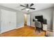Bright bedroom featuring hardwood floors, a spacious closet, and a ceiling fan at 1624 Cone Ave, Apex, NC 27502