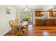 The dining room table is set next to the updated kitchen with stainless dishwasher and granite countertops at 1624 Cone Ave, Apex, NC 27502