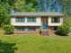 Charming two-story home with blue shutters and brick accents, set on a lush green lawn at 1624 Cone Ave, Apex, NC 27502