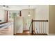 Bright entryway with hardwood floors, staircase, and view into the living room at 1624 Cone Ave, Apex, NC 27502