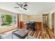 Comfortable living room featuring hardwood floors, a ceiling fan, and a large window at 1624 Cone Ave, Apex, NC 27502