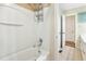 A white shower and tub combo featuring chrome shower head and built in storage at 1624 Cone Ave, Apex, NC 27502