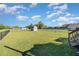 Home featuring a spacious backyard with a well-maintained lawn and a shed at 173 Silver Tee Ct, Selma, NC 27576
