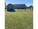 Fenced backyard of a home featuring a well-maintained lawn and shed at 173 Silver Tee Ct, Selma, NC 27576