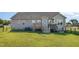 Home featuring a well-maintained backyard with a wooden deck and lush green grass at 173 Silver Tee Ct, Selma, NC 27576