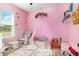 Pink themed bedroom with decorative canopy bed, chair, and natural light from window at 173 Silver Tee Ct, Selma, NC 27576