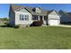 Charming two-story home featuring a well-manicured front yard and attached two-car garage at 173 Silver Tee Ct, Selma, NC 27576