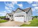 Charming two-story home showcasing a well-manicured front yard and attached two-car garage at 173 Silver Tee Ct, Selma, NC 27576